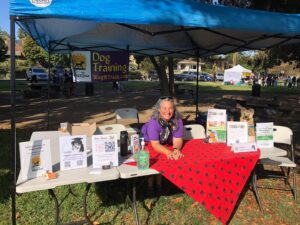 Stacy at a booth table at a pet festival